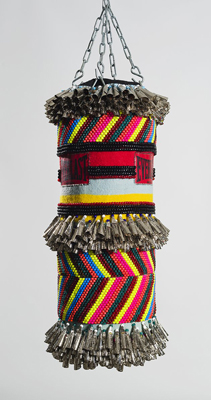 Jeffrey Gibson, Can You Feel It?, 2013, found vinyl punching bag, repurposed wool blanket, glass beads, tin jingles, artificial sinew, acrylic paint, steel hardware, 16 x 32 x 16 inches. Photo courtesy Marc Strauss Gallery